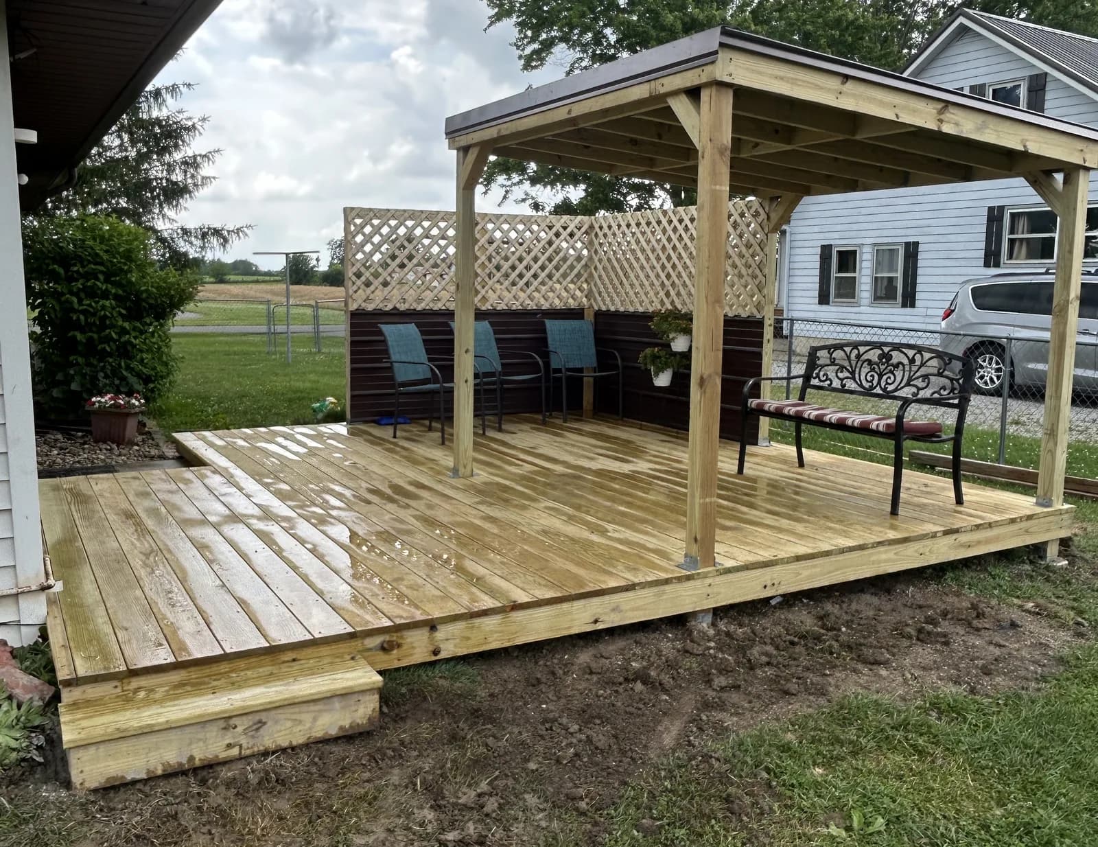 New pressure-treated backyard deck with a custom covered pergola frame