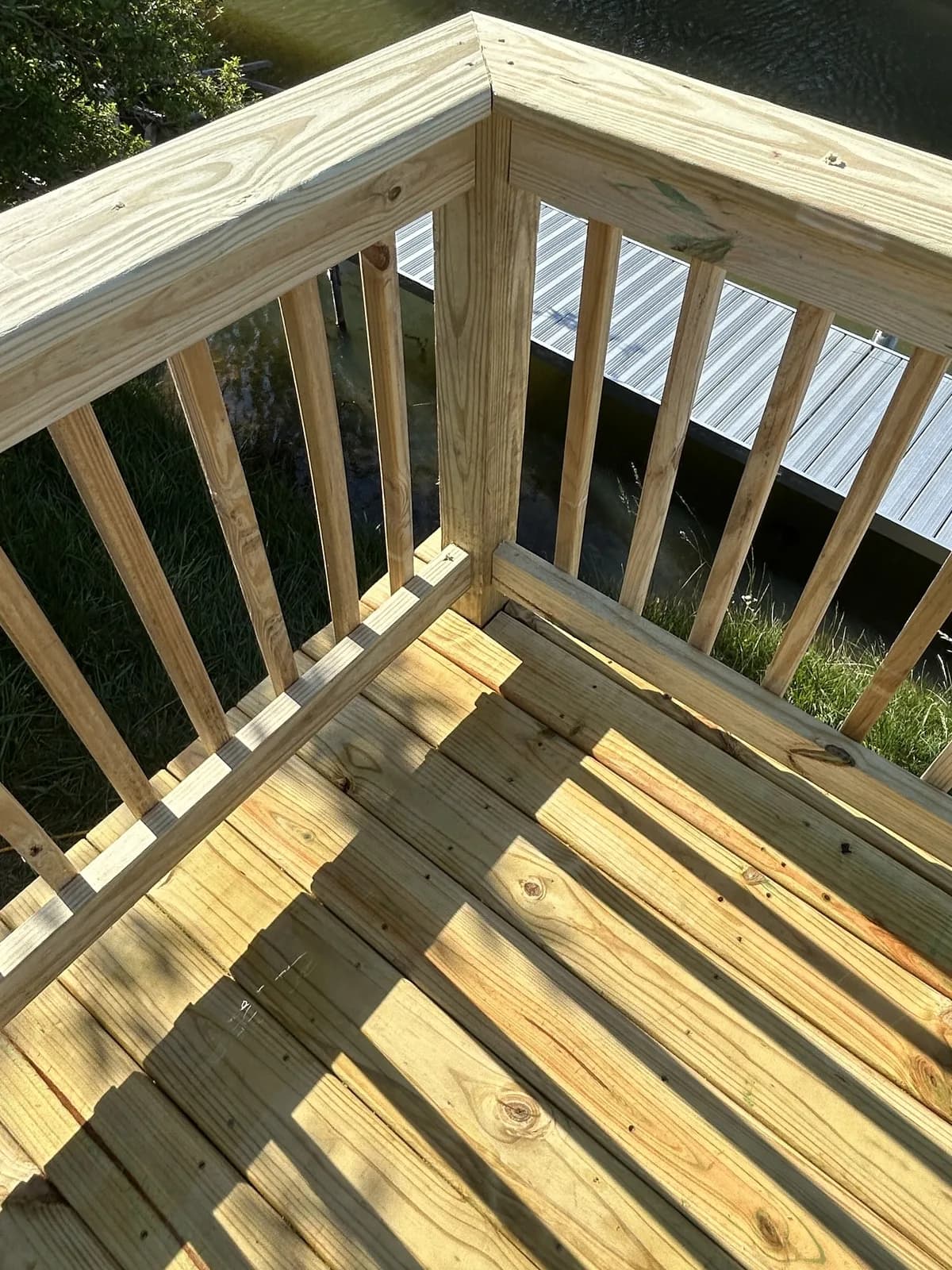 Close-up of pressure-treated wood deck railings and stair craftsmanship