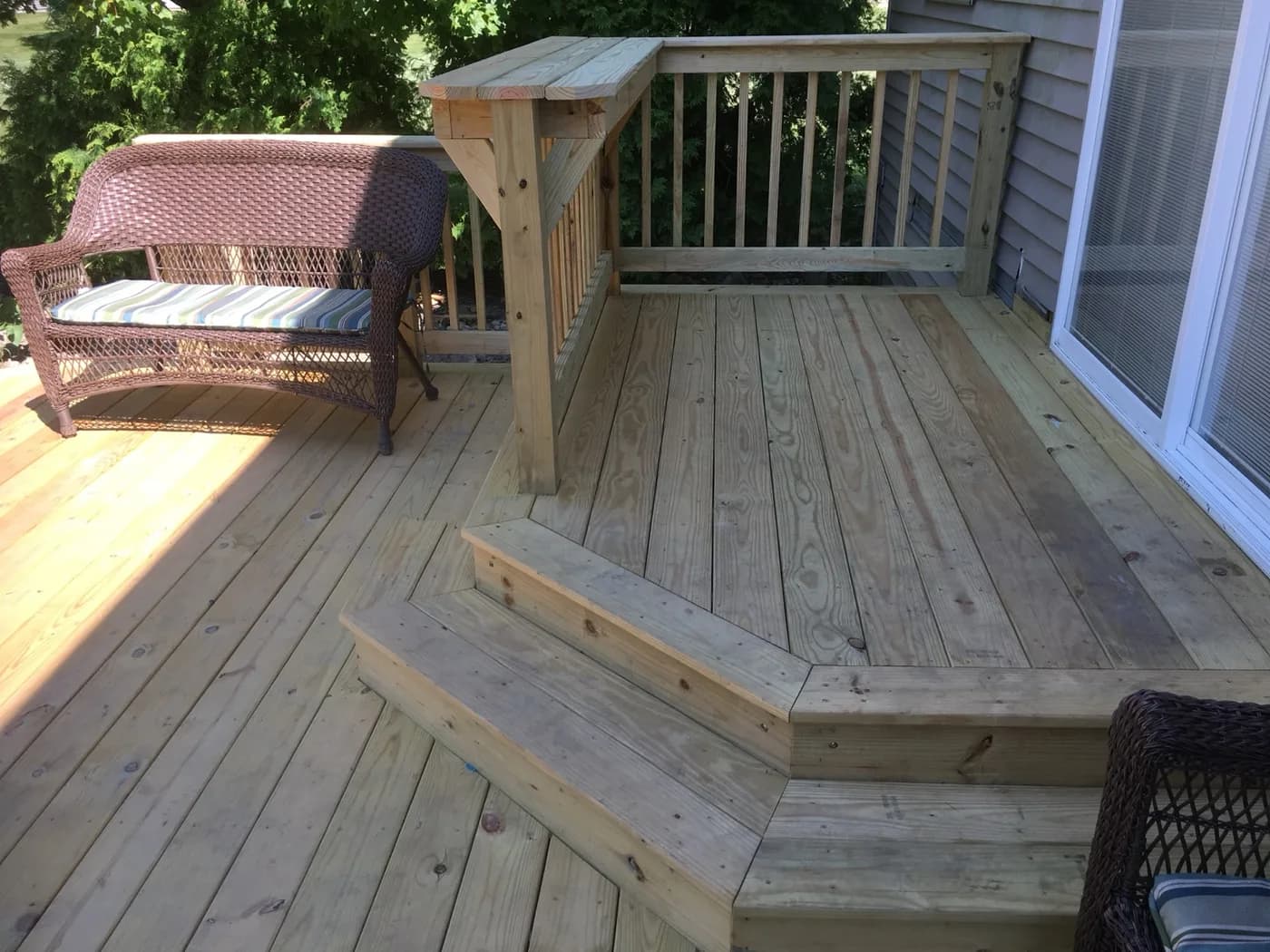 Close-up of cedar deck craftsmanship with wicker seating