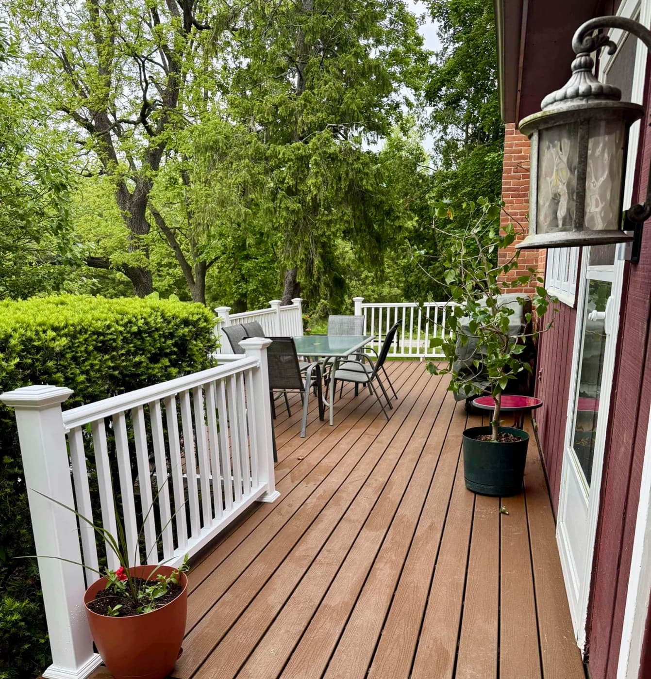 Composite deck with white vinyl railings and outdoor furniture