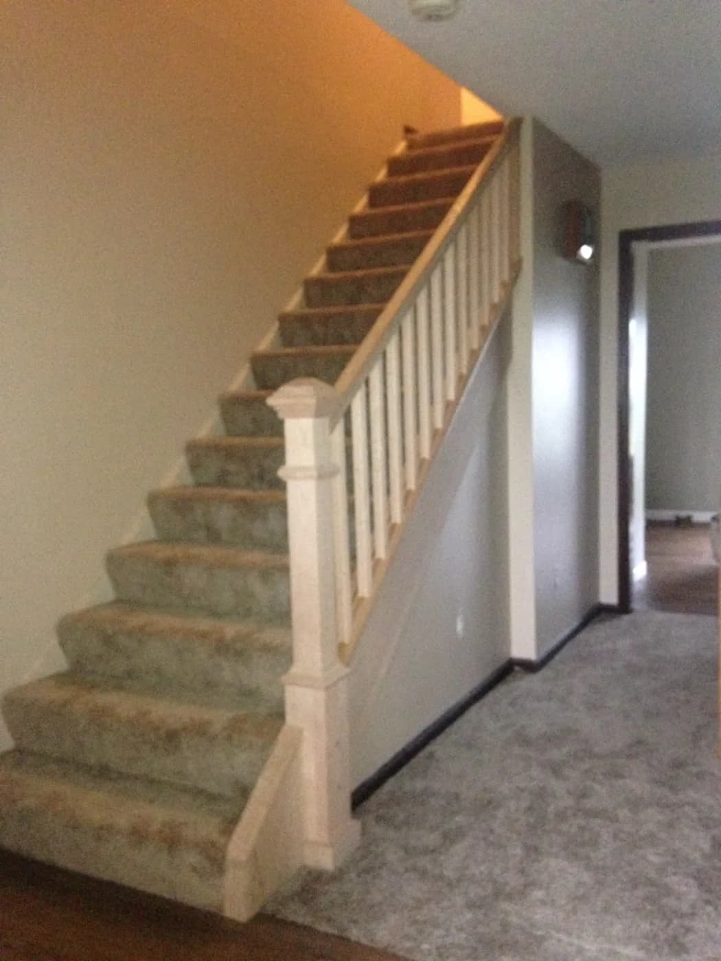Custom interior staircase with wood balusters and carpeted treads