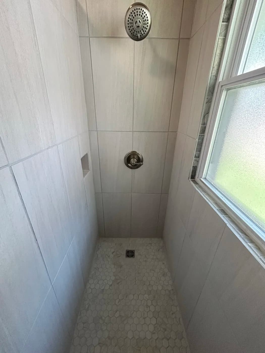 Custom tile shower with skylight and hexagon accent tile